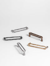 Five sets of natural brass, bronze, carbon black, satin nickel, and polished nickel door pull collections