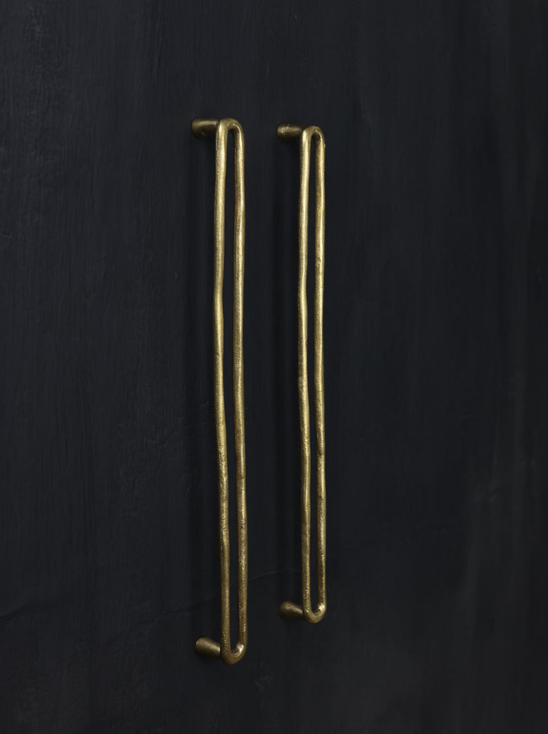 A left side view of the natural brass colored luxury closet pull bar