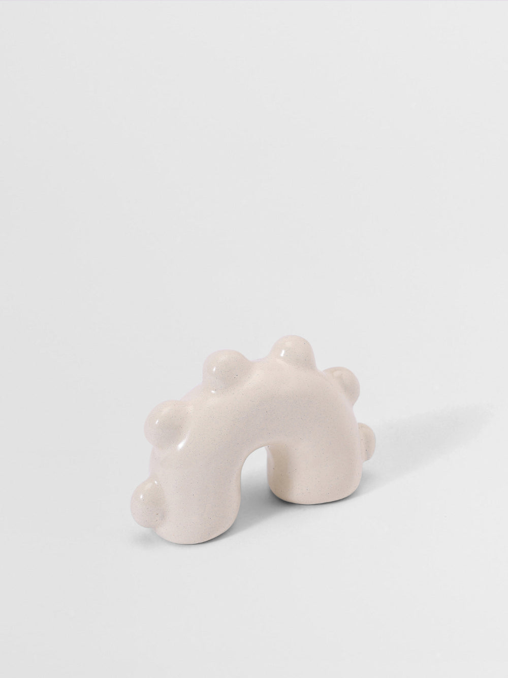 Off White pull knob arch sculpture on a light gray background