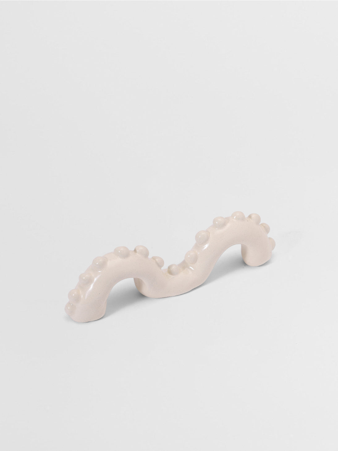 White organic shaped pull on a light gray background