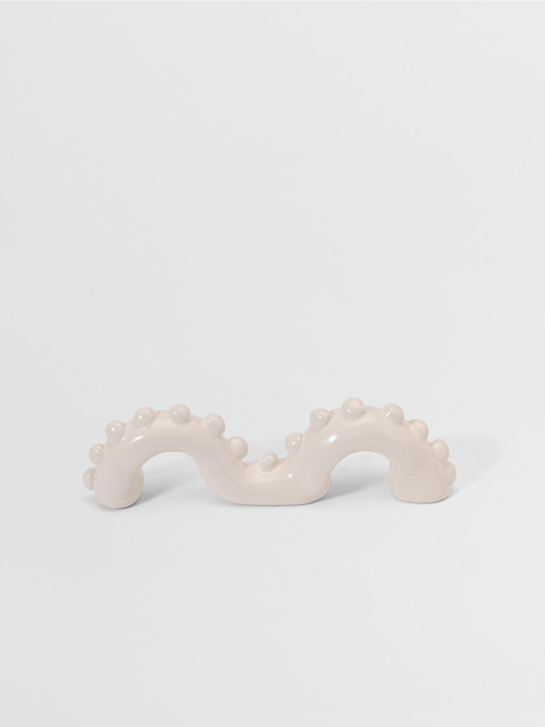 White organic shaped pull on a light gray background