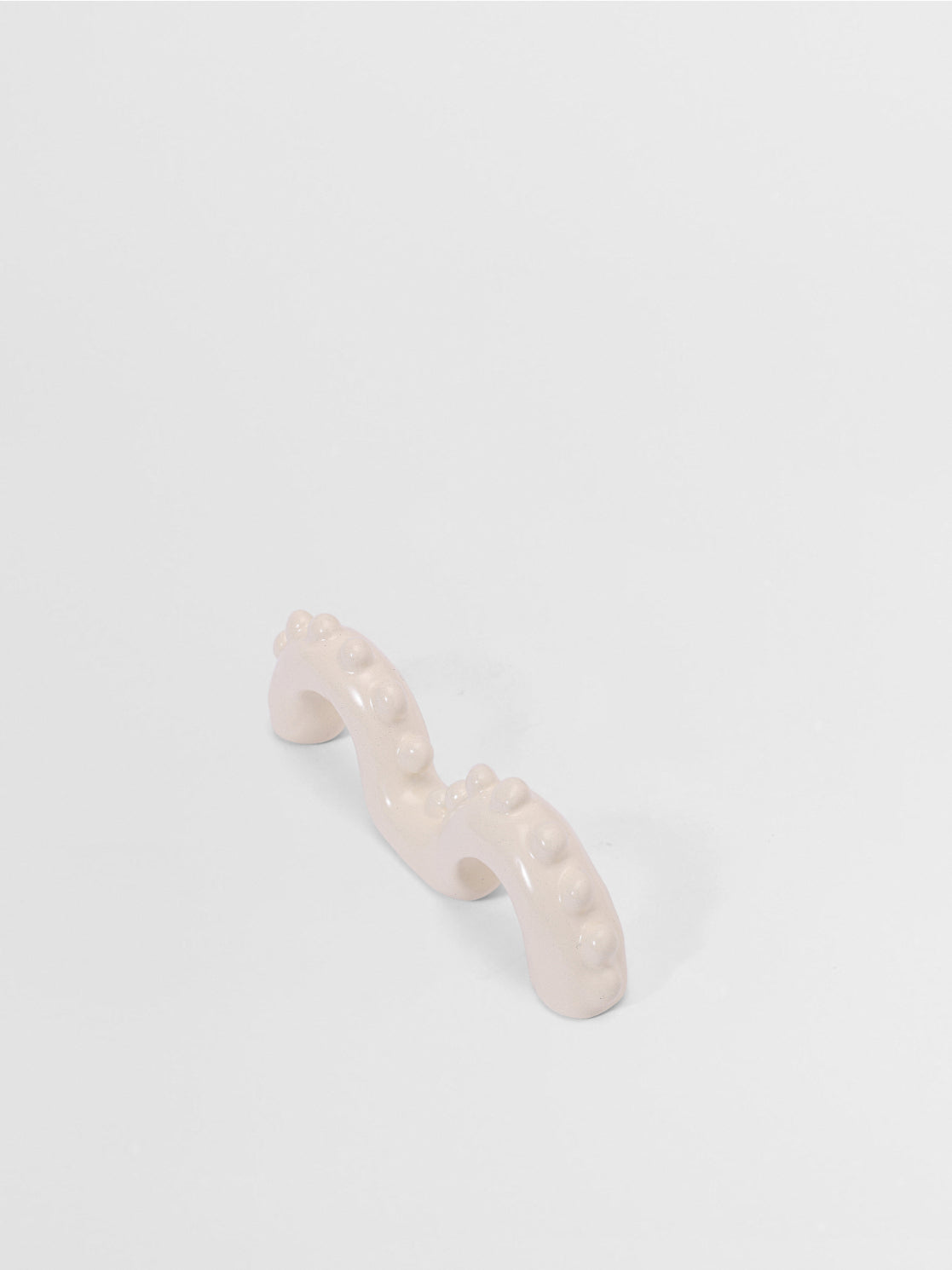 White organic shaped pull on a light gray background
