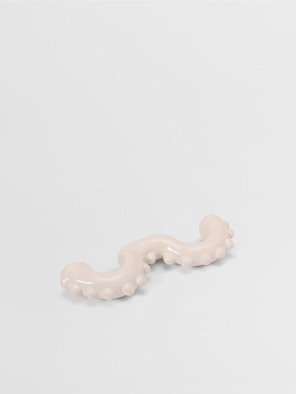 White organic shaped pull on a light gray background