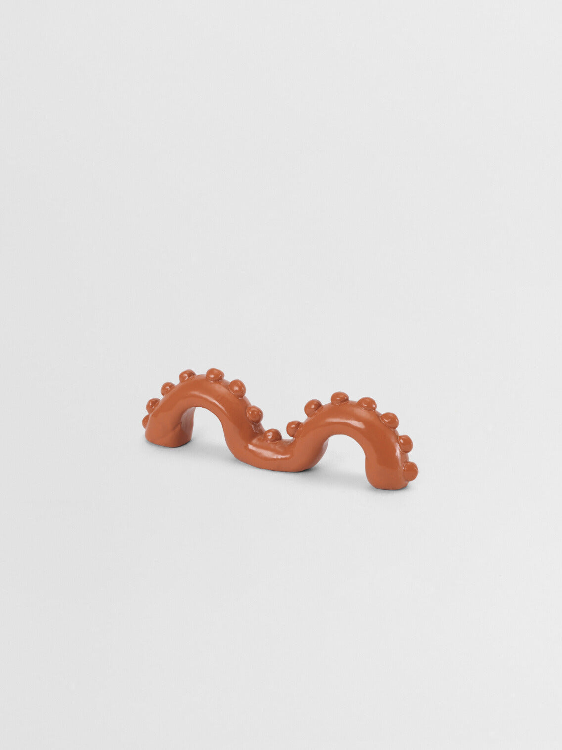 Orange organic shaped pull on a light gray background