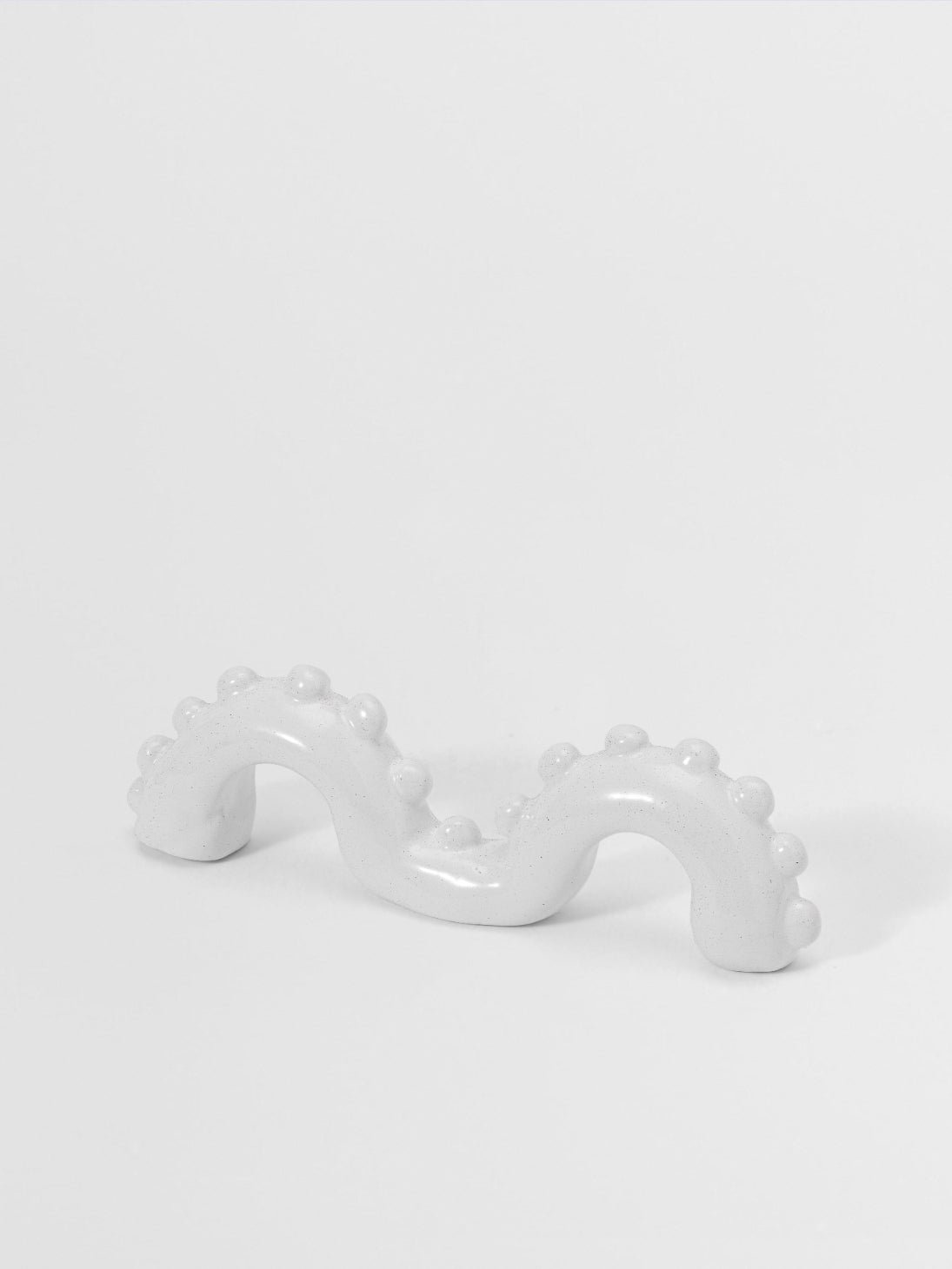 White organic shaped pull on a light gray background