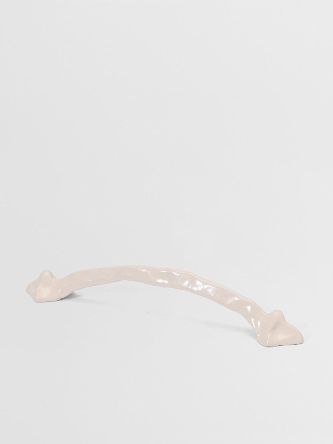 White large pull handle on a light gray background