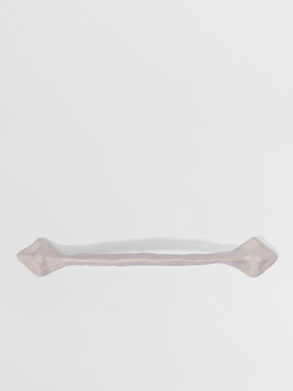 White organic cabinet handleon a white background
