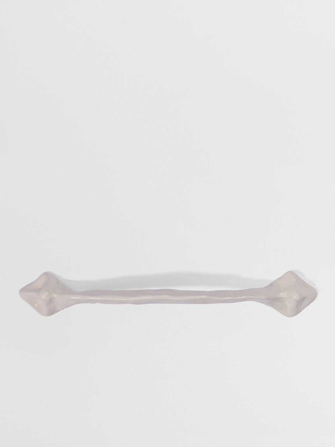 White organic cabinet handleon a white background