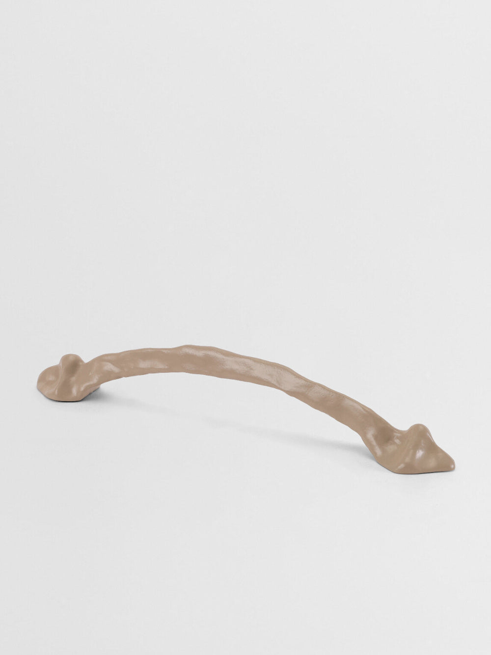 Beige cabinet handle large on a light beige background