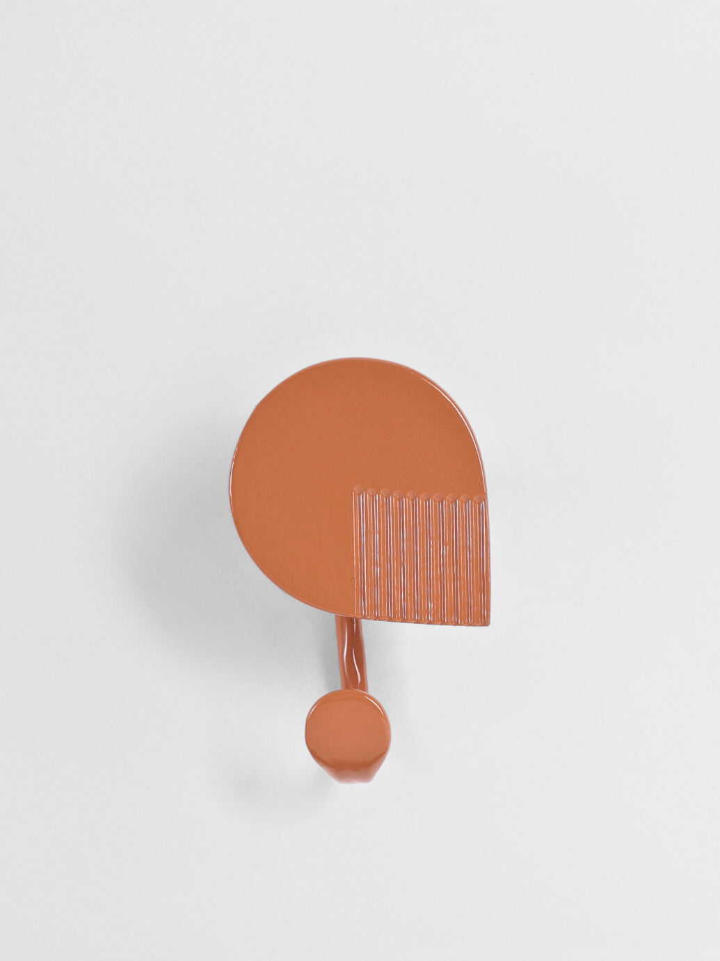 Burnt Orange towel hook on a light gray background