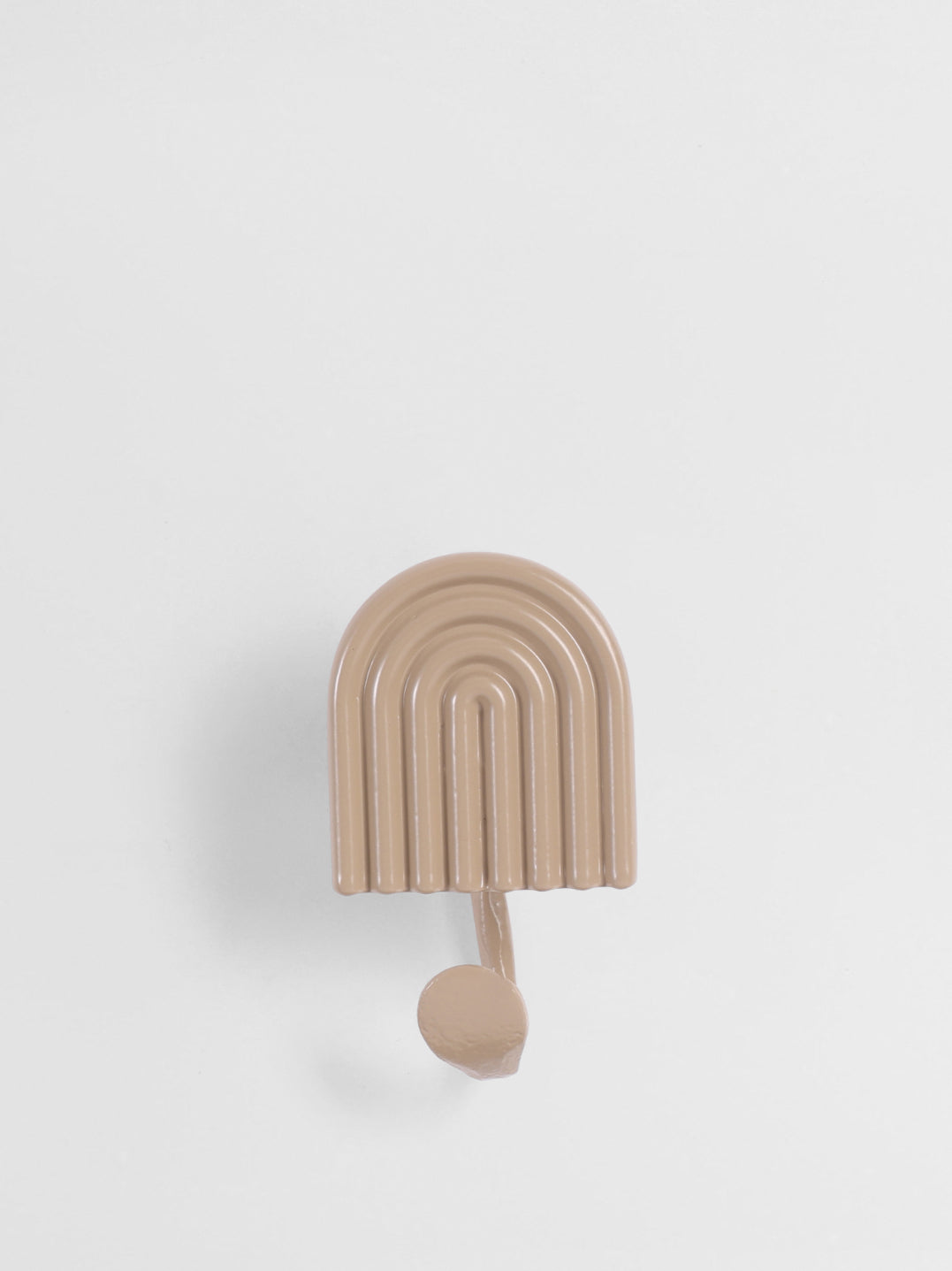 Beige wall hook with arch design on a light gray background