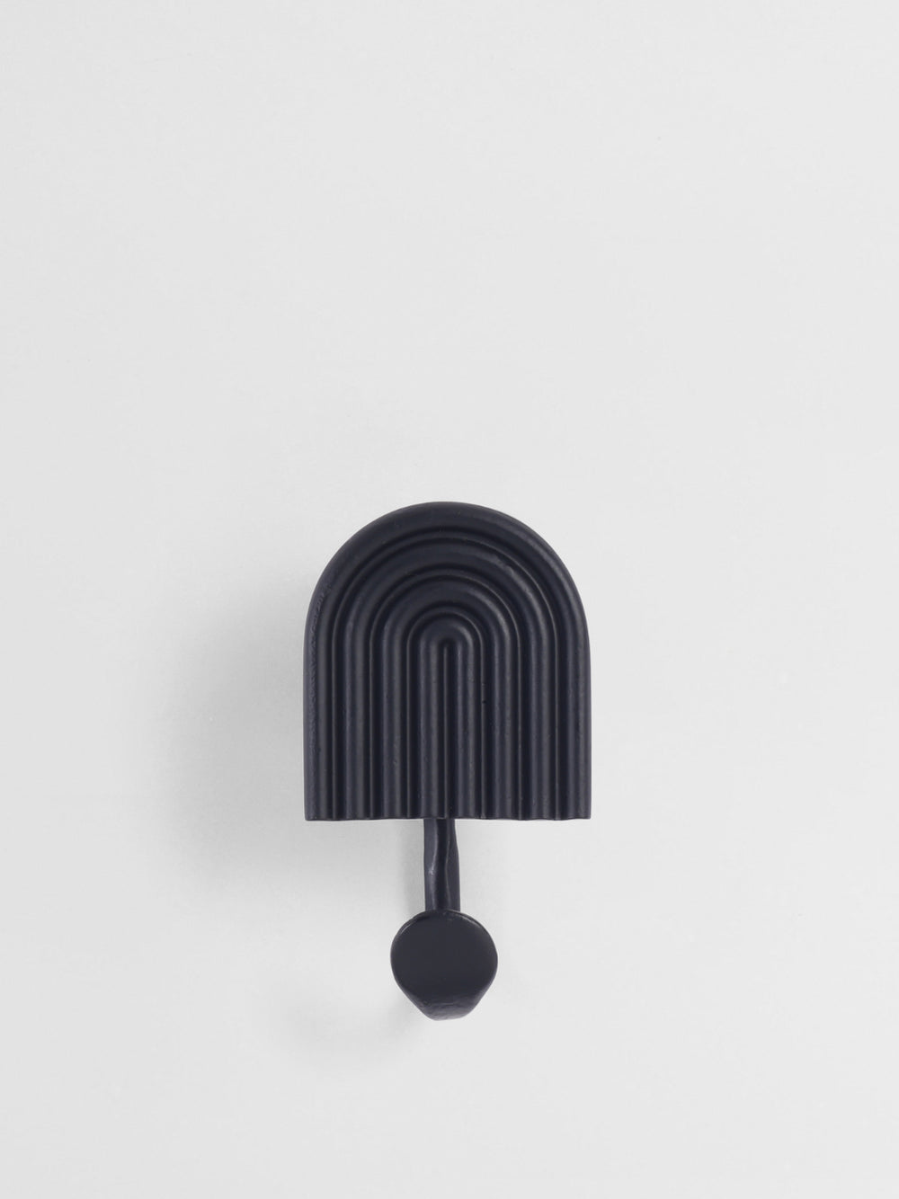 Black wall hook with arch design on a white background