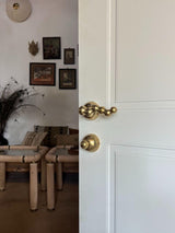Right side view of the natural brass passage door lever - Infinity