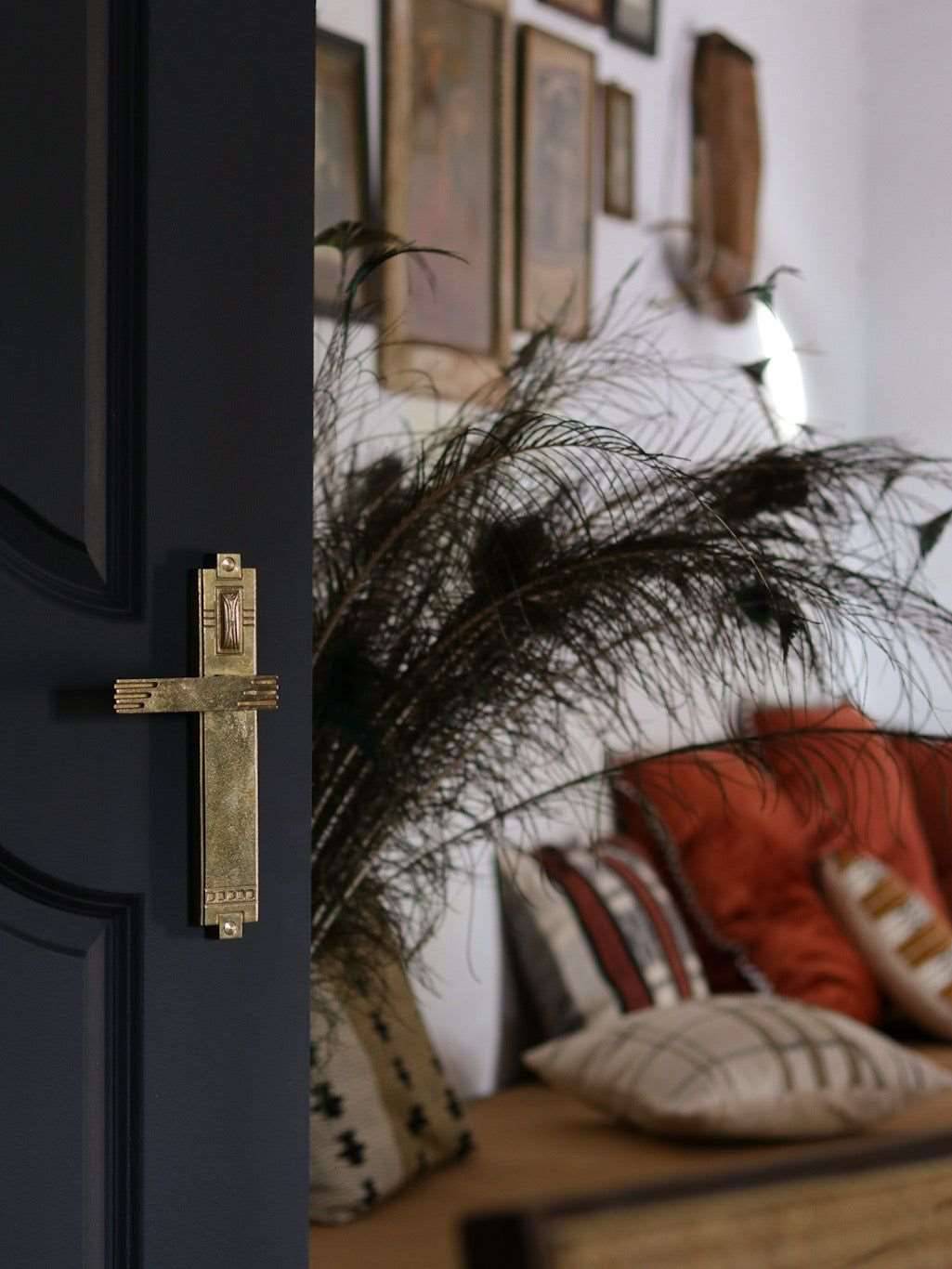 A left side view of a natural brass finish passage door lever set