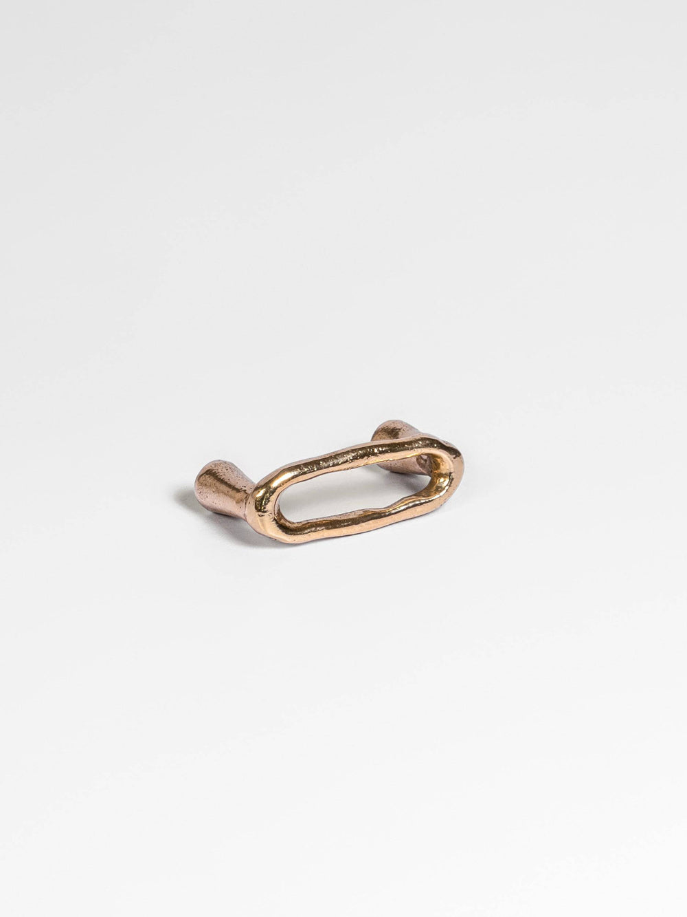 Left side view of a natural brass drawer pull