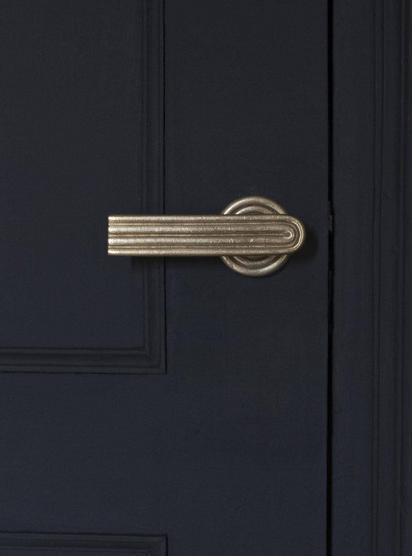 A front view of the natural brass passage door handle set