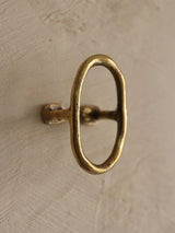 A large view of a bronze colored towel wall hook