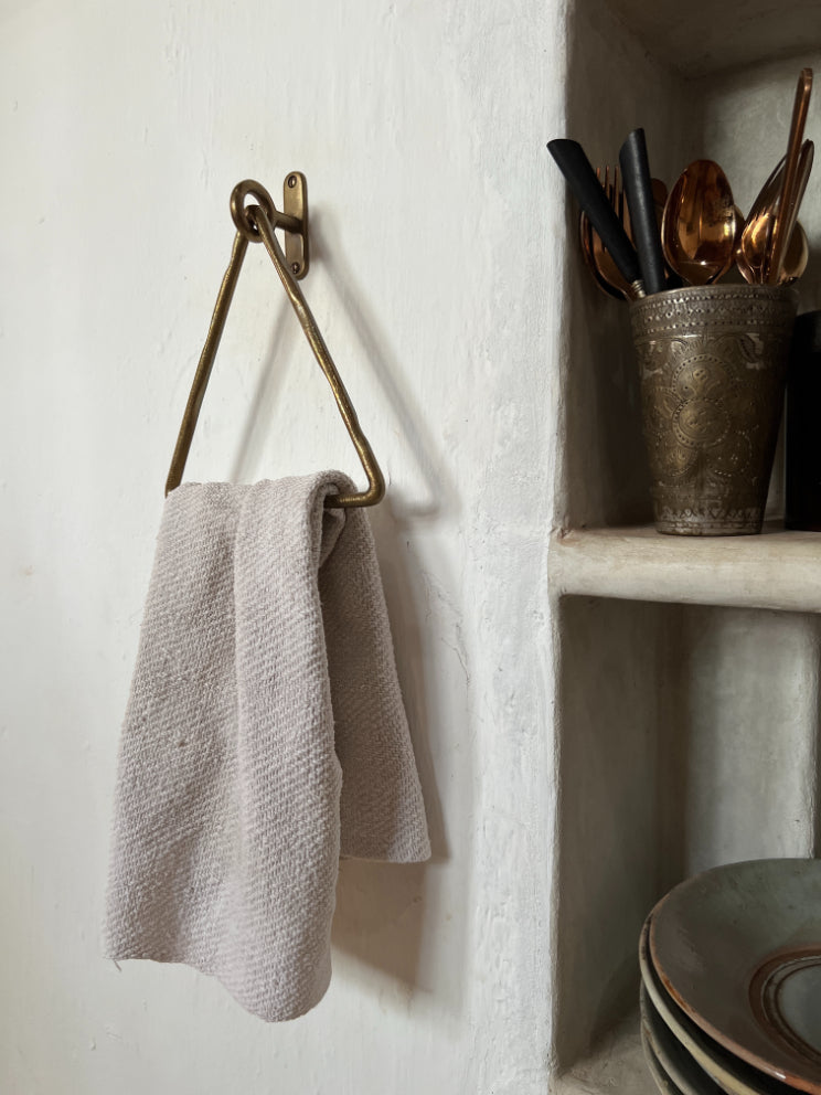 Sculptural triangle-shaped towel hanger in a luxurious champagne bronze finish, blending modern geometry with timeless elegance. Designed for versatile use in both bathrooms and kitchens, this statement piece offers a seamless balance of function and style, elevating any interior with its warm, brushed gold tone.