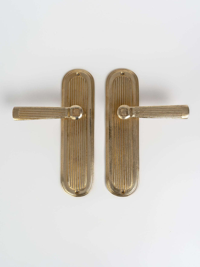 A large left and right view of a brass finish passage door lever set