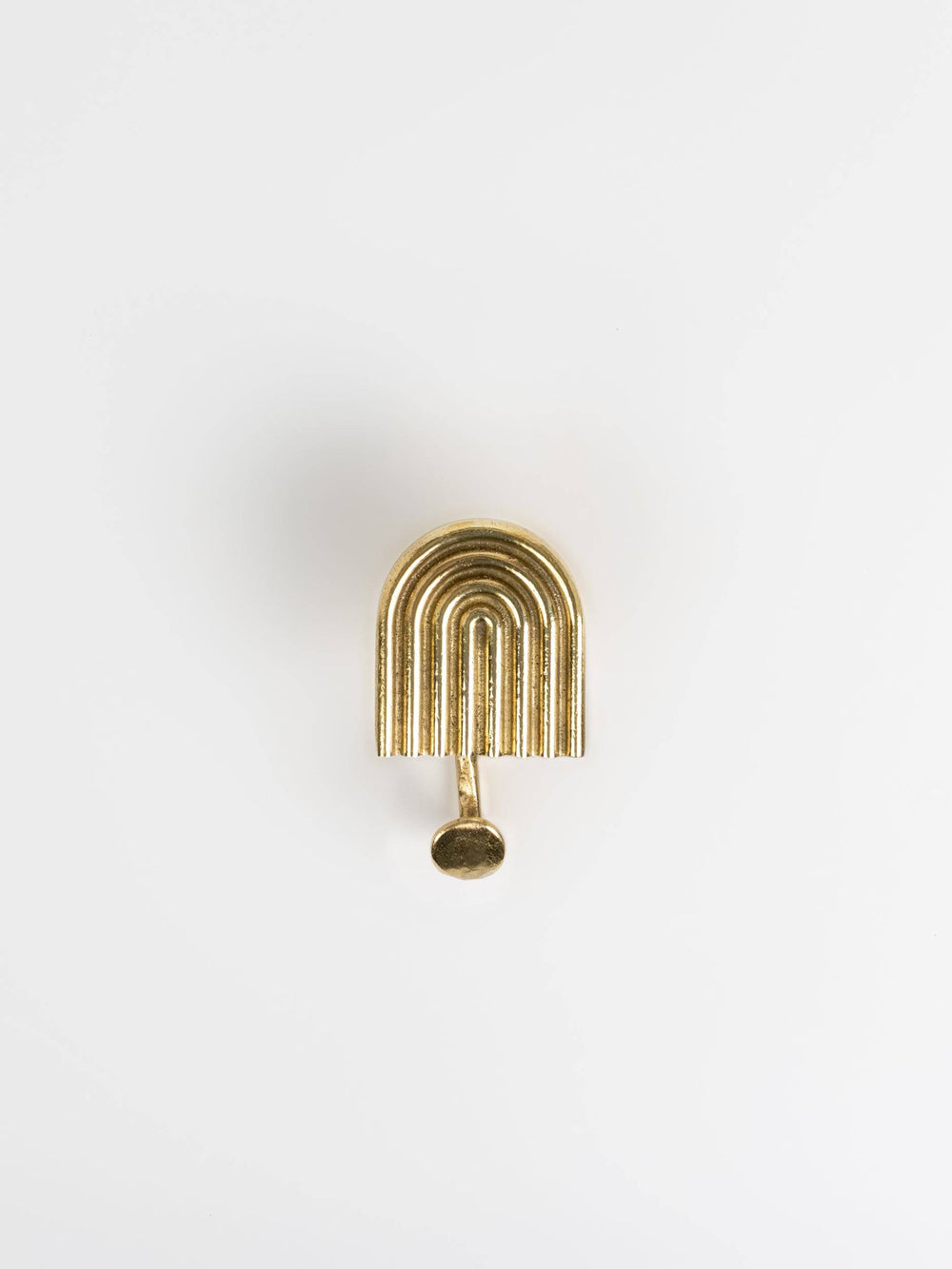 A front view of a natural brass hook brass