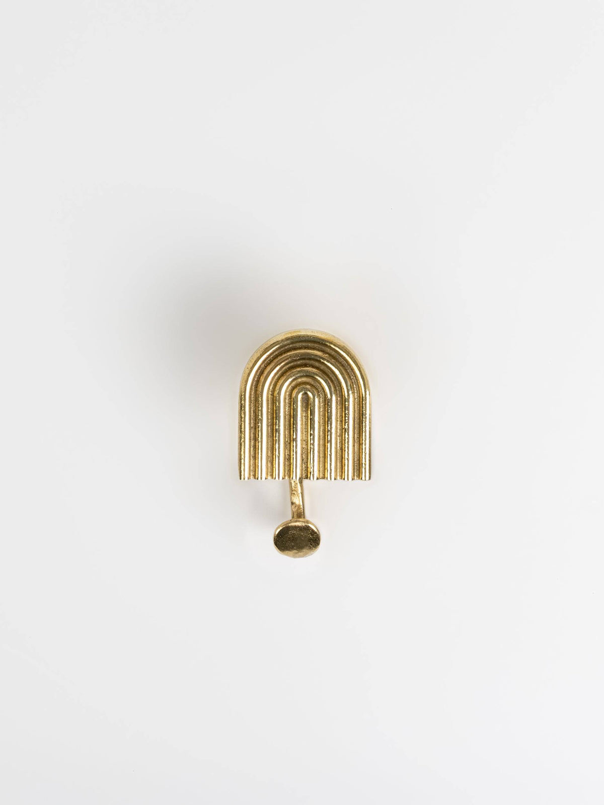 A front view of a natural brass hook brass