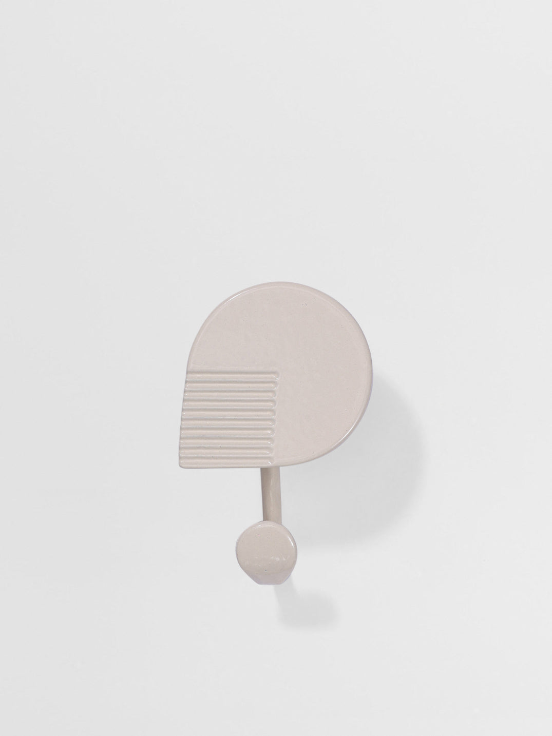 Beige wall hook geometric shape -like design on a white background