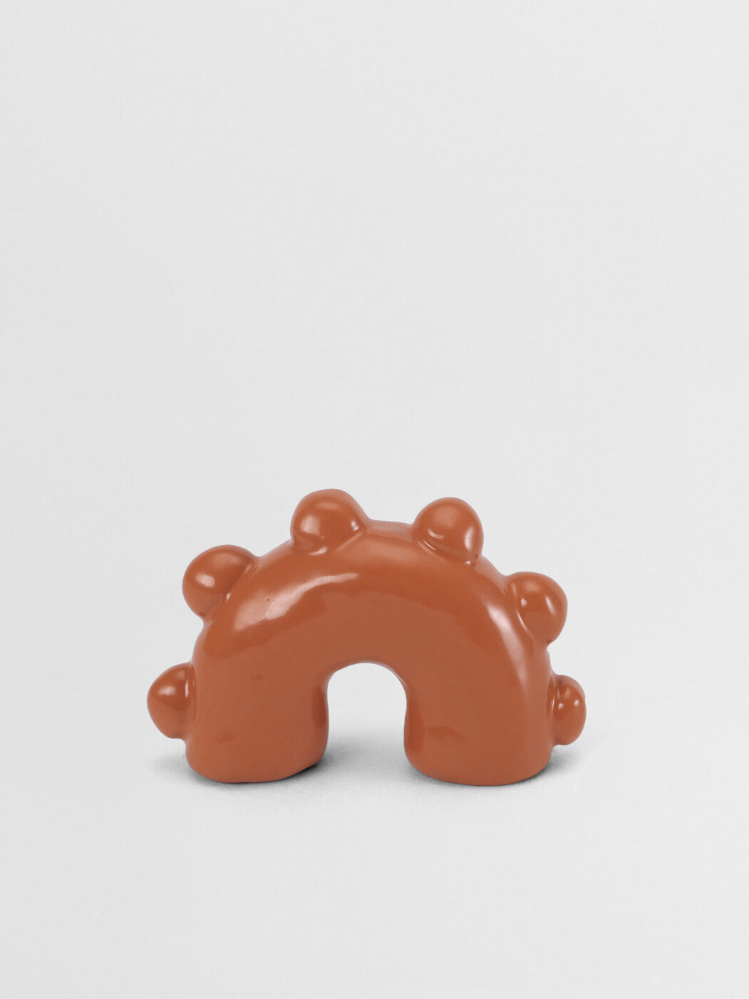 Orange arch-shaped pull on a light gray background