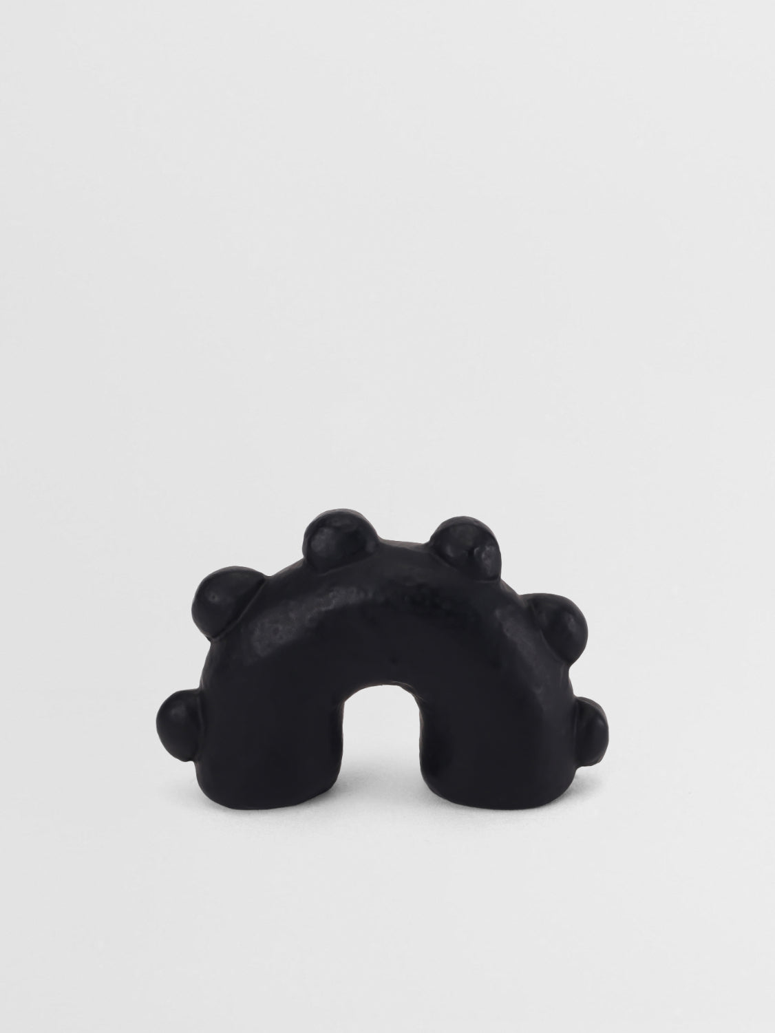 Black matte pull knob ring with a unique design on a white background