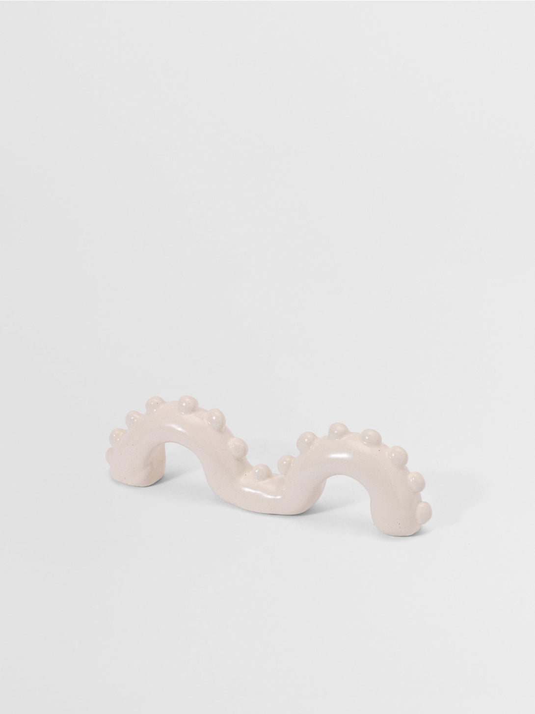 White organic shaped pull on a light gray background