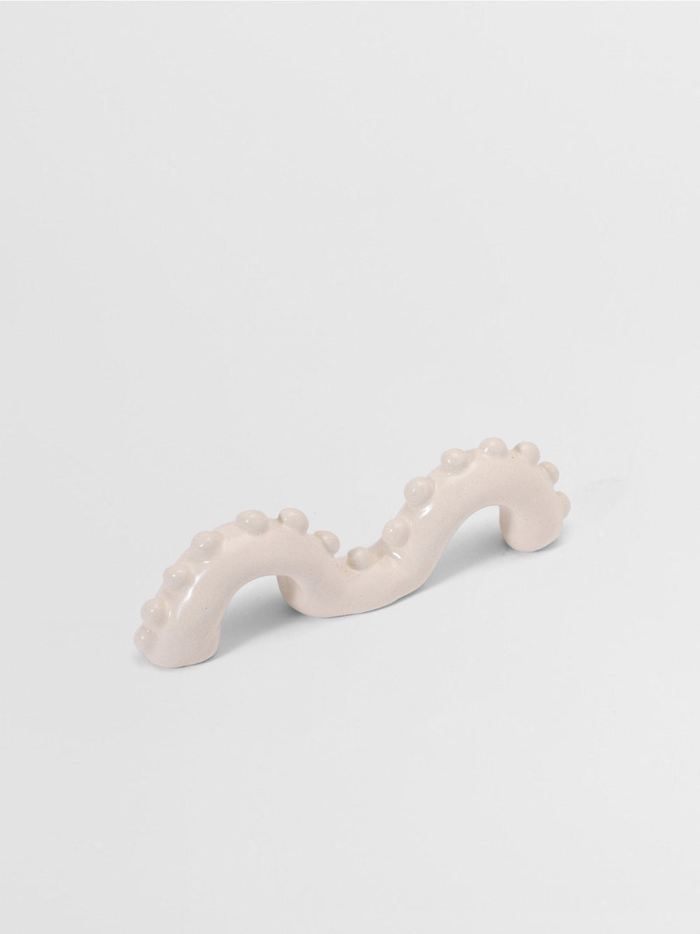 White organic shaped pull on a light gray background