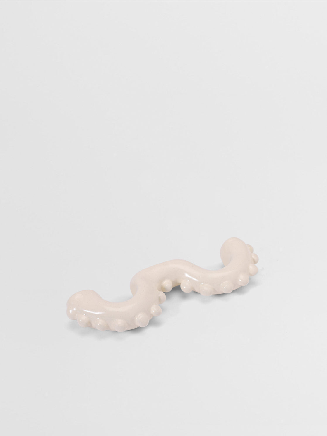White organic shaped pull on a light gray background