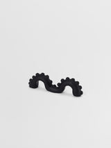 Black  organic shaped pull on a light gray background