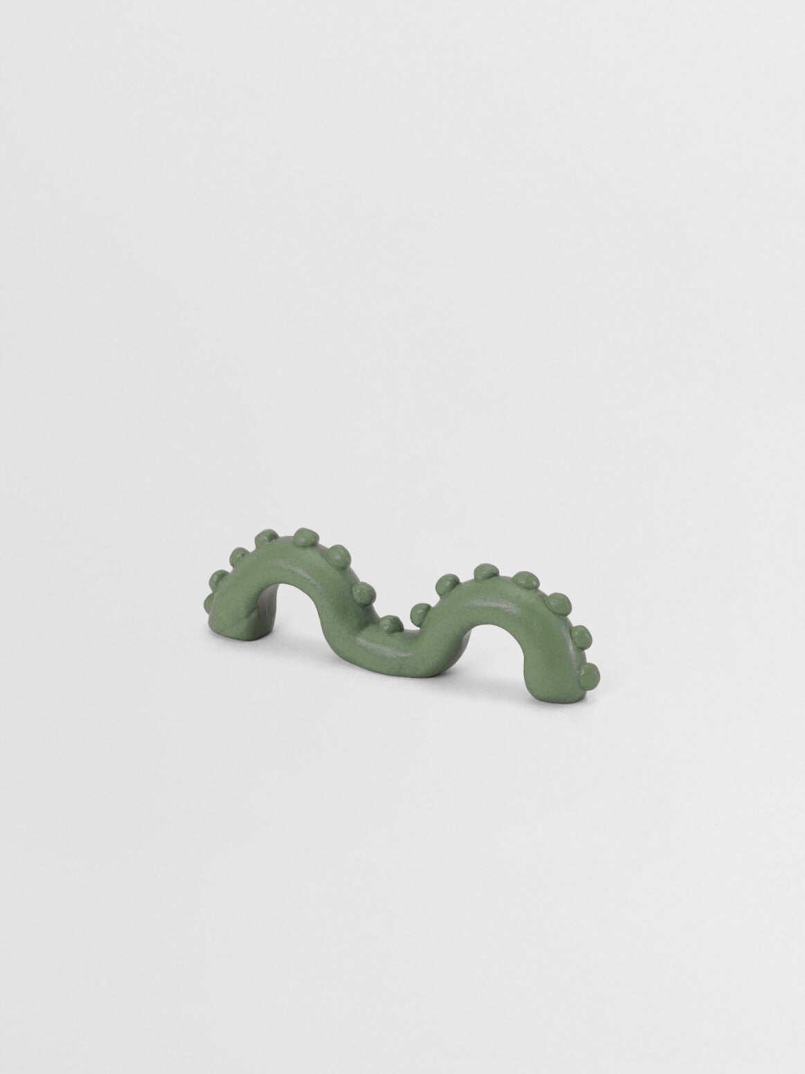 Sage green organic shaped pull on a light gray background