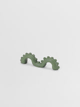 Sage green organic shaped pull on a light gray background