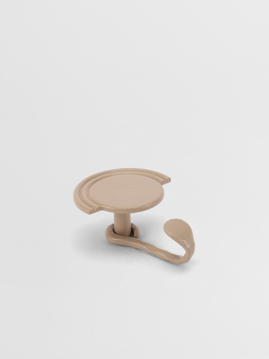 Beige plastic hook on a white background