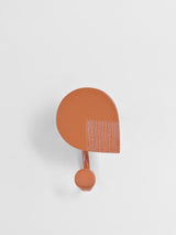Burnt Orange  towel hook on a light gray background