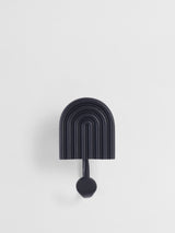 Black wall hook with arch design on a white background