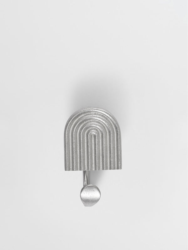 A front view of a natural brass hook brass