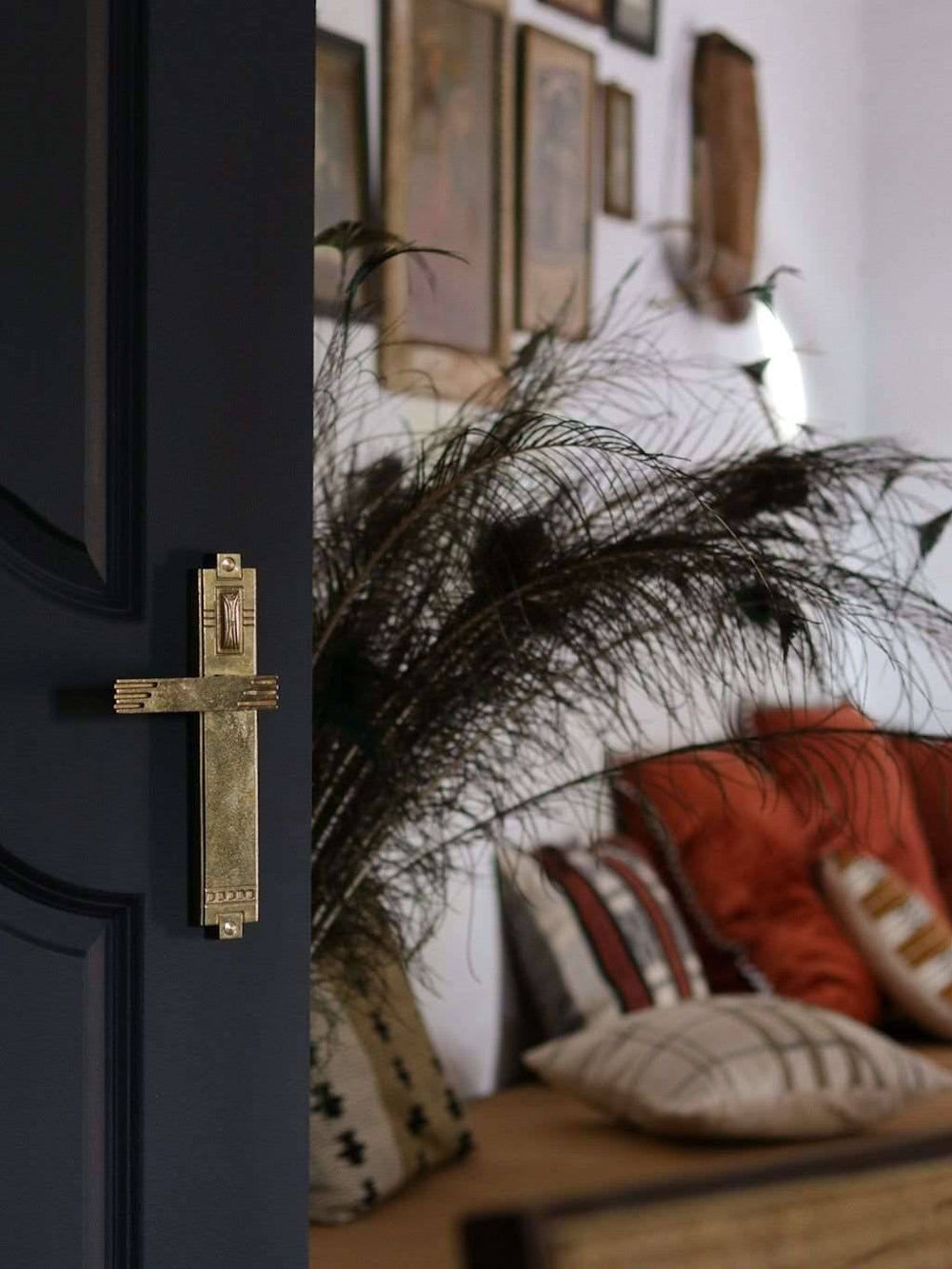 A left side view of a natural brass finish passage door lever set
