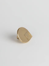  Left side view of a natural brass colored oversized door drawer pull