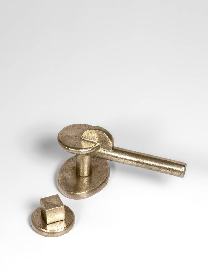 A left side view of a natural brass finish privacy door lever set 