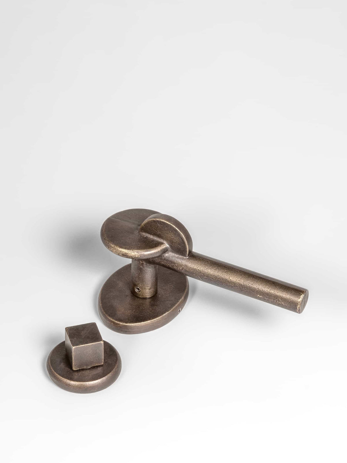 A left side view of a bronze finish privacy door lever set