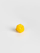A left side view of a yellow colored wall hook