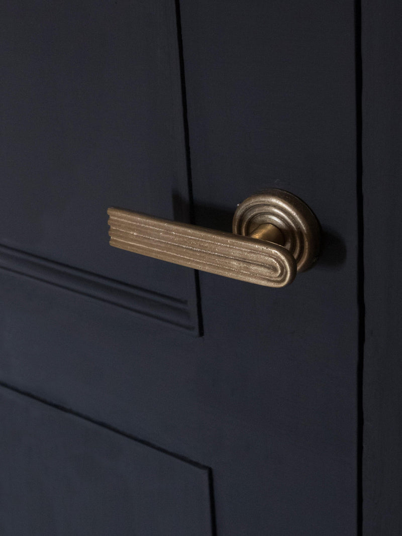 A right side view of the brass passage door handle set